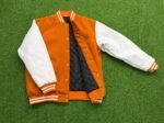 orange and white varsity jacket
